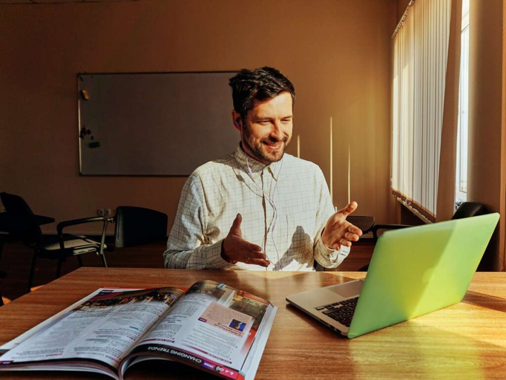 Smiling man looking at the laptop