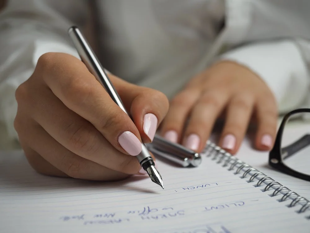 A girl writing something on paper